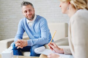 Man receiving counselling by woman